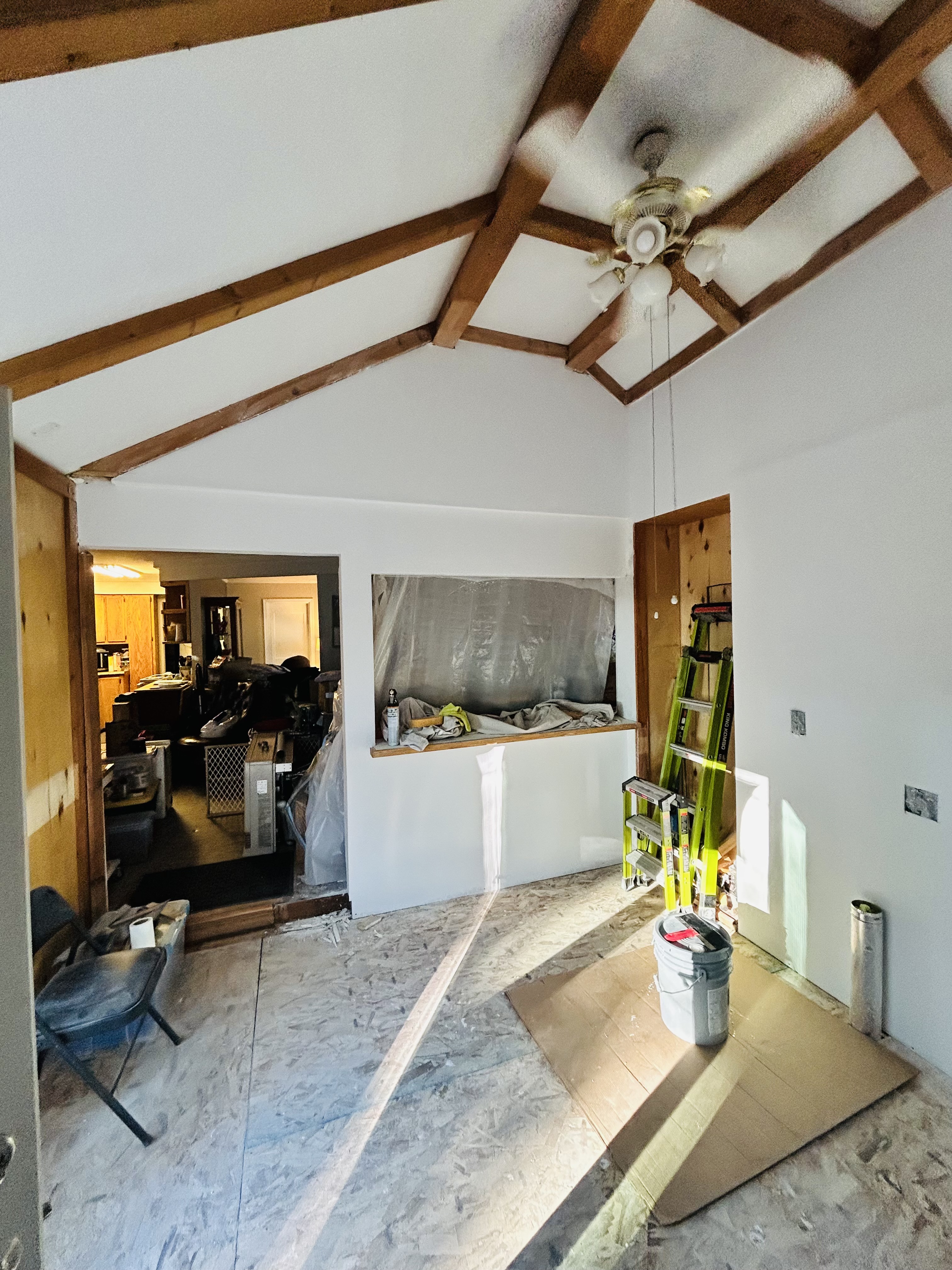 Interior remodel – vaulted beam room, wide angle with pass-through and ladder