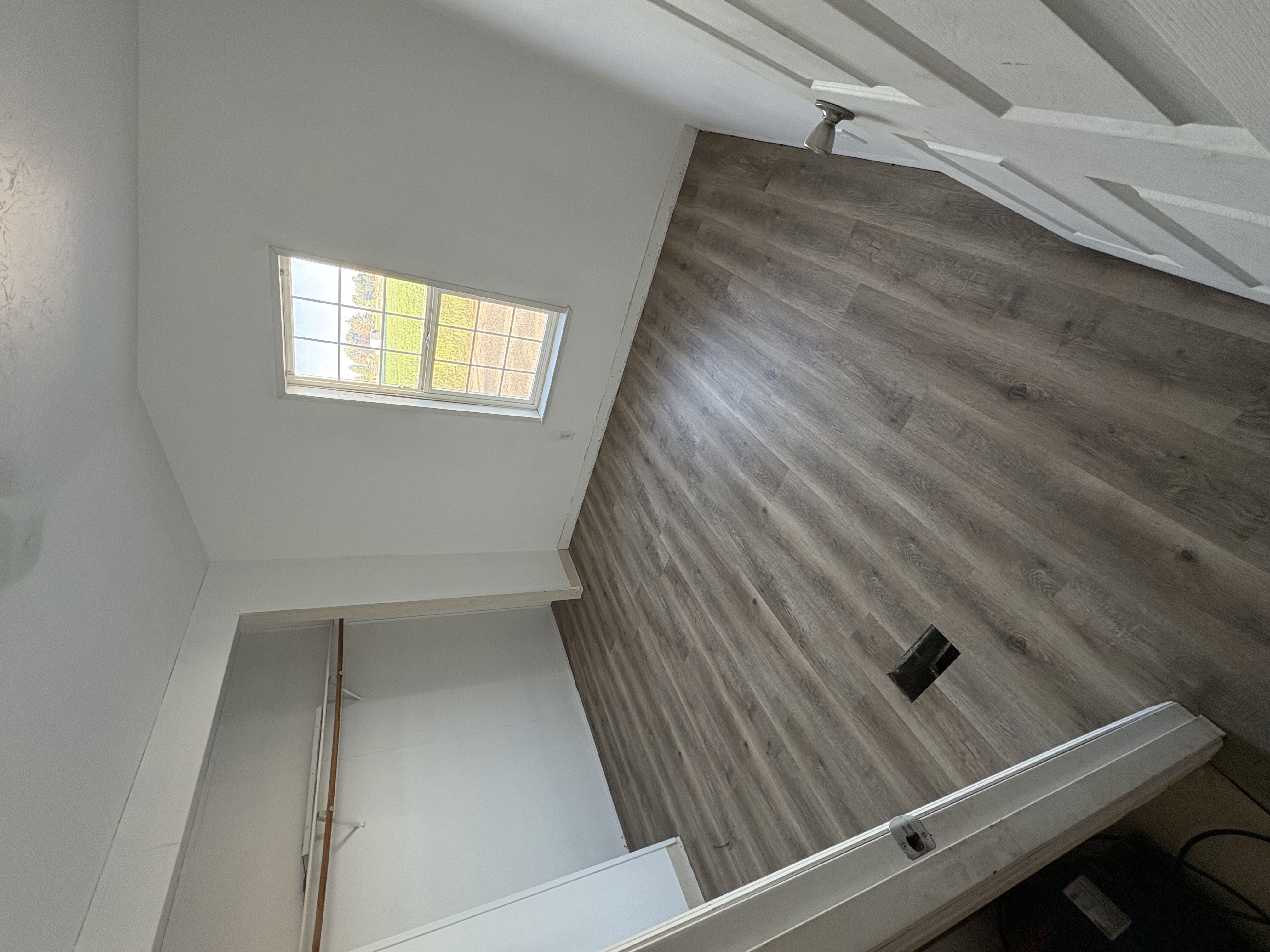 Finished bedroom with new LVP – closet and window