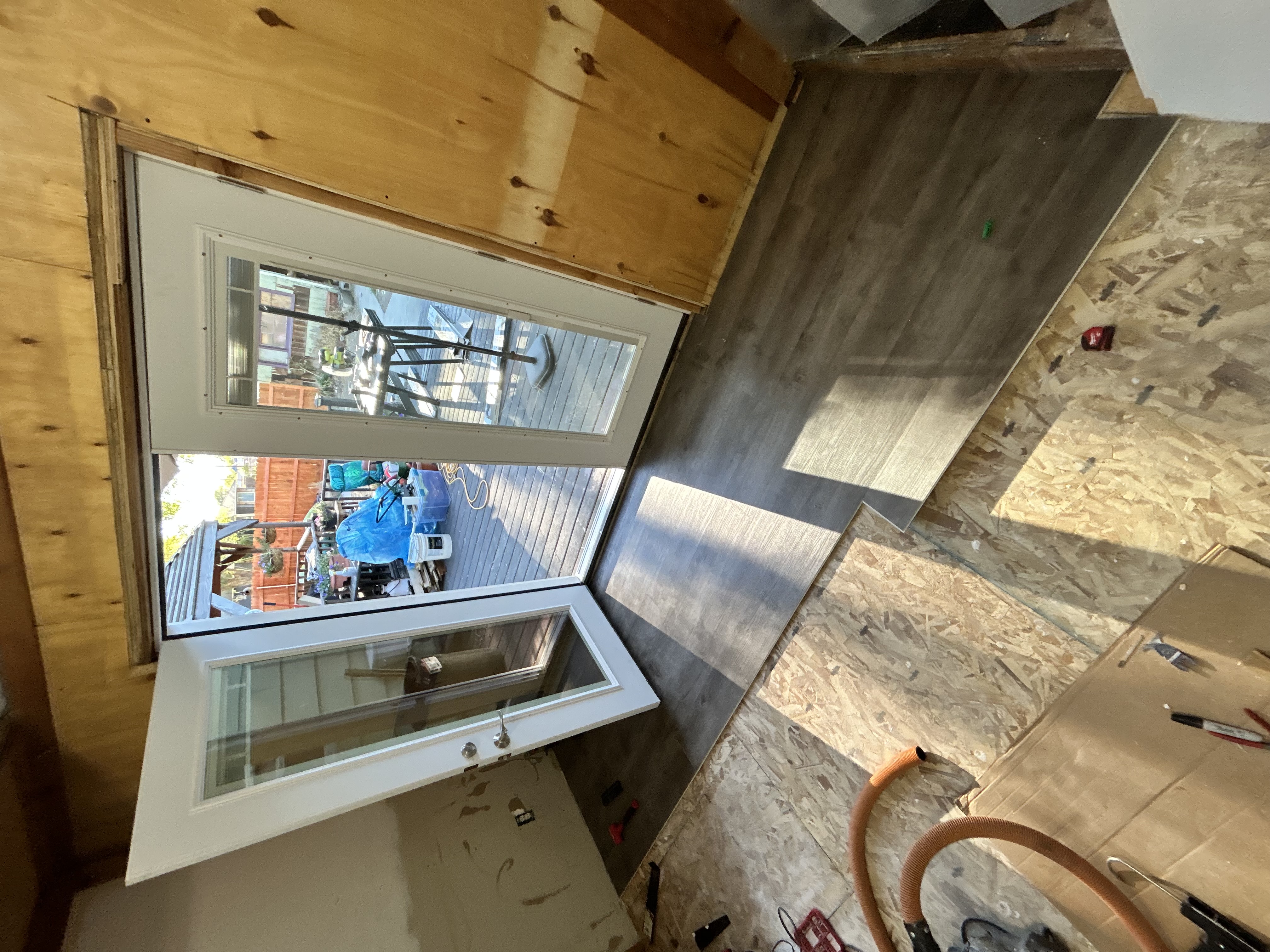 LVP dark plank flooring install mid-progress