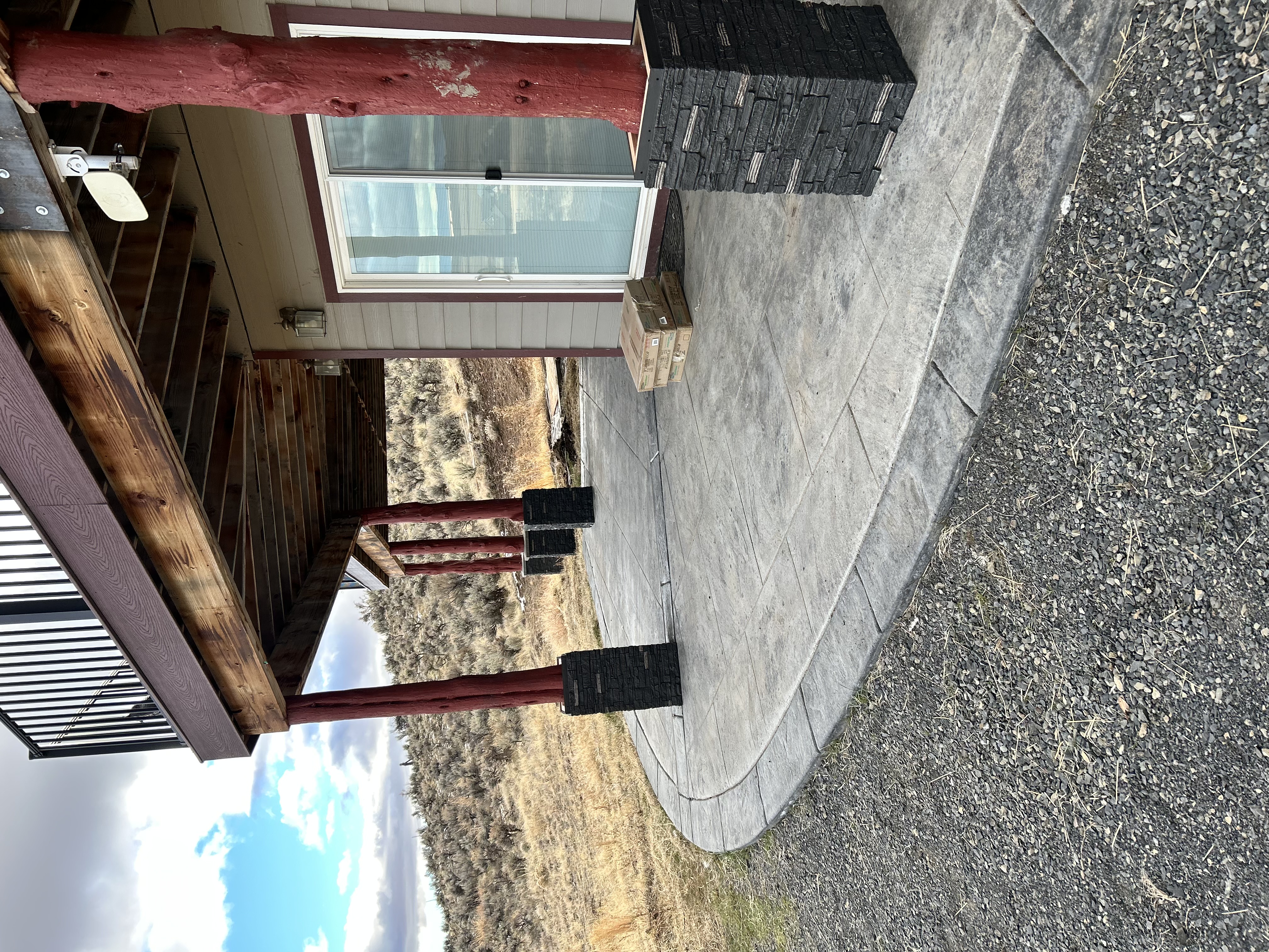 Log cabin back deck – stained deck boards and pergola posts